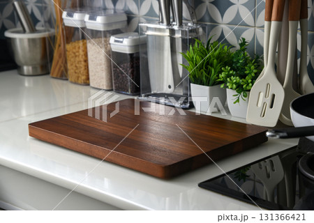 Modern kitchen countertop with blank wooden cutting board 131366421