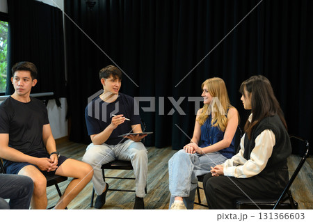Diverse group of people sitting in a circle engaging in open conversation during a therapy session 131366603