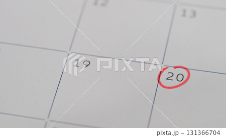 Calendar page with the 20th date marked with a red circle, symbolizing an important reminder 131366704