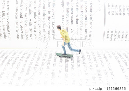 Miniature Skateboarder On Large Text Pages Creates Creative Paper Miniature Skateboarder On Large Text Pages Creates Creative Paper 131366836