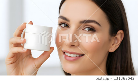 Smiling woman holding white jar of facial cream for skincare Smiling woman holding white jar of facial cream for skincare 131368042