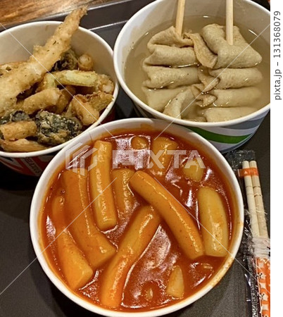 Bunsik, a popular Korean street food, features comforting and savory dishes like tteokbokki (spicy rice cakes), odeng (fish cake skewers), and kimbap (seaweed rice rolls). Perfect for quick meals. 131368079