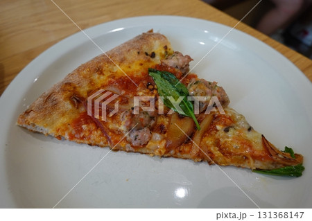 Hot and cheesy pizza slice with a crispy crust and savory toppings. A perfect mix of melty goodness and bold flavor for a satisfying comfort food favorite. Hot and cheesy pizza slice with a crispy crust and savory toppings. A perfect mix of melty goodness and bold flavor for a satisfying comfort food favorite. 131368147