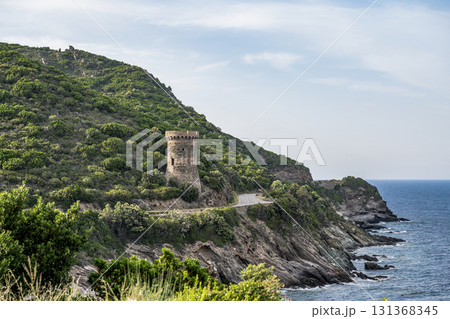 Watchtower view Roadtrip Winding road along rocky coast of Cap Corse peninsula on Corsica island France 131368345