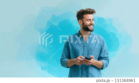 Smiling man holding smartphone wearing blue shirt with beard and short hair on blue background 131368961