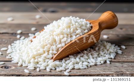 White rice grain wooden scoop rustic table closeup natural food ingredient healthy cooking 131369151