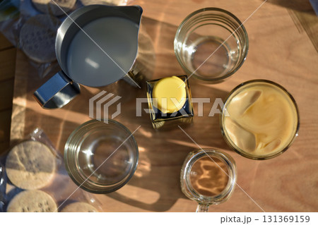Iced caramel latte with milk and glassware on wooden table top view Iced caramel latte with milk and glassware on wooden table top view 131369159