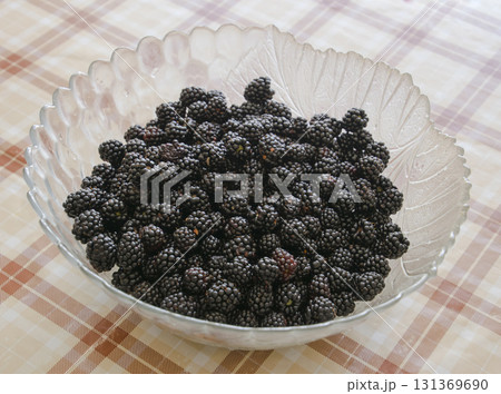 Plate with berries black blackberries. Fruits berries on the table Plate with berries black blackberries. Fruits berries on the table 131369690