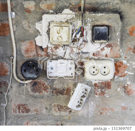 Old panel with switches and sockets. Old electrical wiring Old panel with switches and sockets. Old electrical wiring 131369707