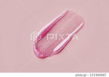 Glittery pink lip gloss smear on soft pink background Glittery pink lip gloss smear on soft pink background 131369897