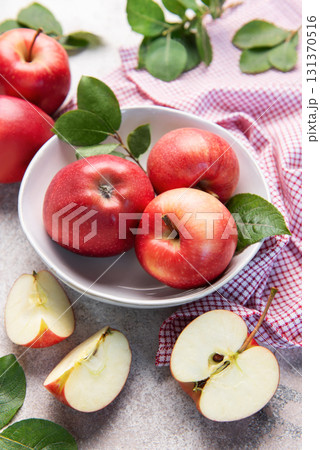 Fresh red apples in white bowl on table 131370516