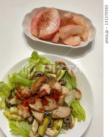 Fresh vegetable salad with a vibrant mix of greens, cherry tomatoes, cucumbers, and bell peppers. Crisp, colorful, and packed with vitamins, this salad makes a healthy, delicious meal or side. 131370565