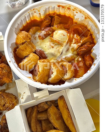 Chewy rose yeotteok coated in spicy pink sauce paired with a crispy corndog, blending sweet, savory, and spicy flavors. A trendy Korean street food duo perfect for food promotions. Chewy rose yeotteok coated in spicy pink sauce paired with a crispy corndog, blending sweet, savory, and spicy flavors. A trendy Korean street food duo perfect for food promotions. 131370579