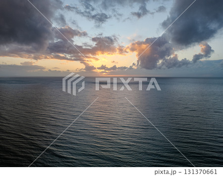 A Serene Ocean Sunset featuring Beautifully Dramatic and Colorful Clouds in the Sky A Serene Ocean Sunset featuring Beautifully Dramatic and Colorful Clouds in the Sky 131370661