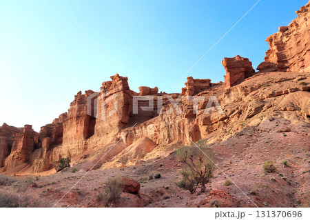 Picturesque scenery of Charyn Canyon in the sunset light, northern region of Tien Shan Mountains. Famous landmark Natural monument Valley of Castles, National Nature Park, Almaty region, Kazakhstan Picturesque scenery of Charyn Canyon in the sunset light, northern region of Tien Shan Mountains. Famous landmark Natural monument Valley of Castles, National Nature Park, Almaty region, Kazakhstan 131370696