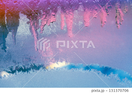 Natural artictic texture of melting ice on the frozen window in colorful light. Gradient color. Abstract Christmas background 131370706
