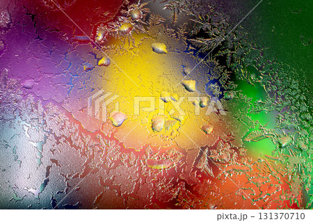 Natural artictic texture of melting ice on the frozen window in colorful light. Abstract Christmas background 131370710