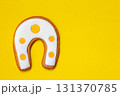 Horseshoe ginger cookies on the yellow background 131370785