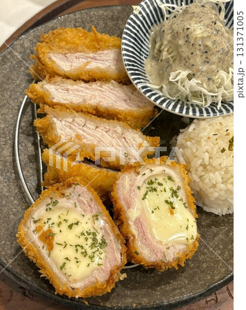 Crispy tonkatsu, a Japanese-style breaded and deep-fried pork cutlet, served with shredded cabbage and drizzled with savory sauce. A delightful balance of crunchy texture and juicy meat. 131371005