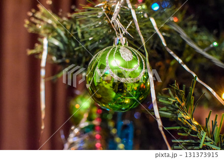 Decorations New Year tree. Tinsel and toys, balls and other decorations on the Christmas Christmas tree standing in the open air. 131373915
