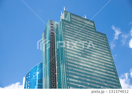 glass tower skyscraper on blue sky, view from below. contemporary building, geometric design in urban landscape 131374012