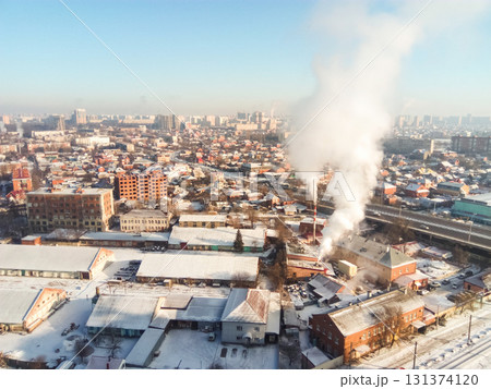 Winter town. Frosty sunny day in the city. Snow on the streets and smoke from the boiler rises. Frost and sun, a wonderful day Winter town. Frosty sunny day in the city. Snow on the streets and smoke from the boiler rises. Frost and sun, a wonderful day 131374120