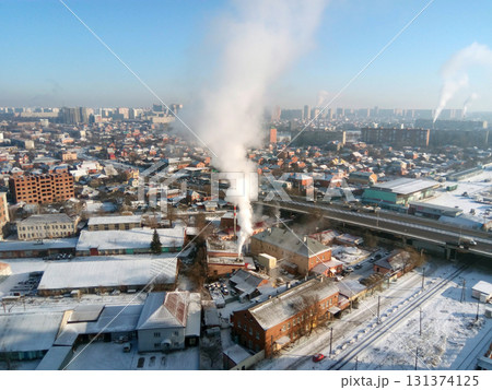 Winter town. Frosty sunny day in the city. Snow on the streets and smoke from the boiler rises. Frost and sun, a wonderful day 131374125