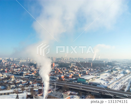 Winter town. Frosty sunny day in the city. Snow on the streets and smoke from the boiler rises. Frost and sun, a wonderful day 131374131