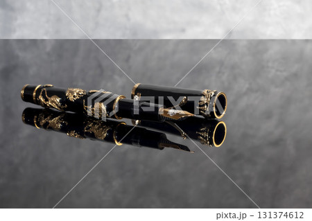 A fountain pen against a dark marble background. Rare writing instruments. 131374612
