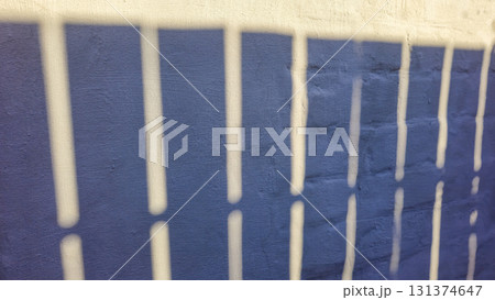 Old concrete wall, natural texture. Light background. Shadows from the fence. Old concrete wall, natural texture. Light background. Shadows from the fence. 131374647