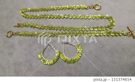 Handmade round earrings made of seed beads and glass beads on a light background 131374654