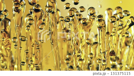 Freeze Motion of Abstract Oil Splashes on Golden Background. Oil Drops Flying up in the Air. Concept of Beauty, Serum, Fuel or Fry. 131375115