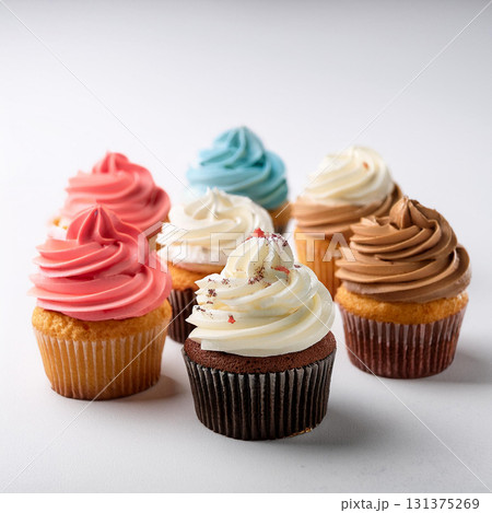 Colorful Cupcakes Displayed on White Table 131375269