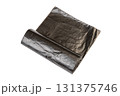 roll of black plastic garbage bags for waste collection and storage isolated on white background. New rolled plastic bin bags 131375746