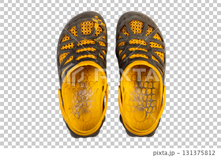 paint stained and heavily worn yellow black sandals. top view 131375812