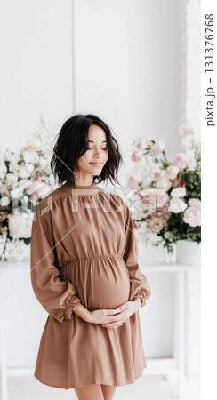 Pregnant woman with afro hairstyle smiling softly indoors, copy space Pregnant woman with afro hairstyle smiling softly indoors, copy space 131376768