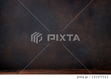 Rustic charm: Wooden table against a textured stone wall Rustic charm: Wooden table against a textured stone wall 131377313