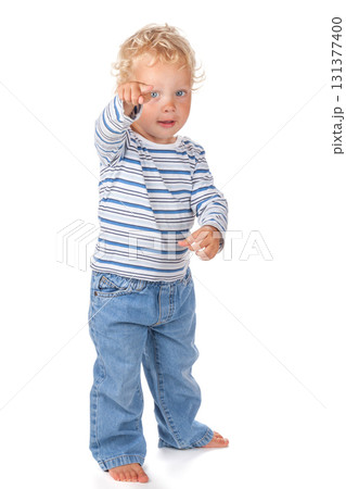A cute and funny blue-eyed baby dressed in jeans A cute and funny blue-eyed baby dressed in jeans 131377400