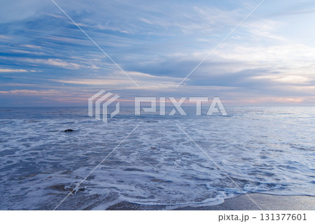 Sunset over the ocean in Malibu with colorful sky and tranquil waves Sunset over the ocean in Malibu with colorful sky and tranquil waves 131377601