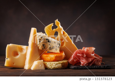 Assorted cheeses in different shapes and textures displayed together 131378123
