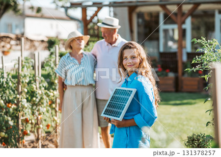 Family promoting renewable energy with solar technology at home. Family promoting renewable energy with solar technology at home. 131378257