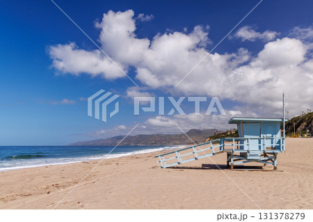Lifeguard tower on a California ocean beach with golden sand and waves 131378279