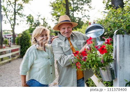 Happy elderly couple enjoying gardening in countryside. Happy elderly couple enjoying gardening in countryside. 131378400