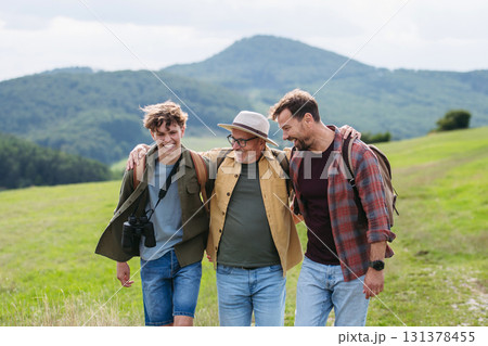 Grandfather, father and teen boy hiking togeter in nature, spending time together during weekend. Grandfather, father and teen boy hiking togeter in nature, spending time together during weekend. 131378455