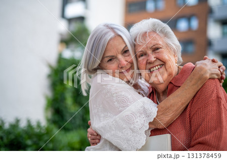 Portrait of beautiful adult daughter with old mother. 131378459