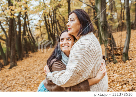 Mature daughter with older mom in the middle of fores, hugging. Mother's day concept. 131378510