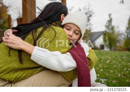 Portrait of beautiful mother with young daughter in the middle of autumn garden. 131378525