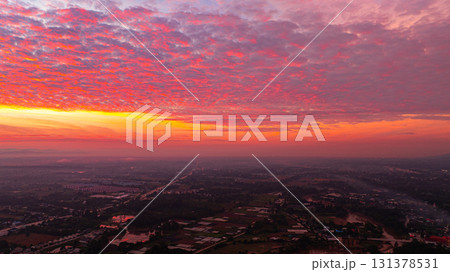 Aerial view of Clouds streak the sunlight above unban village. 131378531