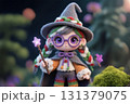 Witch crochet doll girl holding magic wand standing in the garden. 131379075