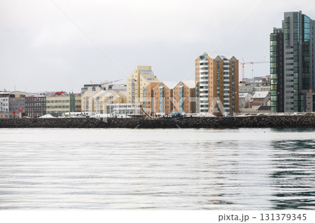 Reykjavik, Iceland, a tranquil harbor scene along a rocky breakwater Reykjavik, Iceland, a tranquil harbor scene along a rocky breakwater 131379345
